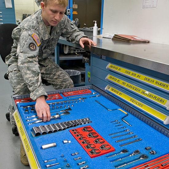 Military man opening a drawer of a cabinet